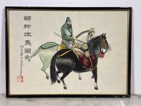 Full view of framed Chinese watercolour painting depicting a man on a black horse and a white horse, including calligraphy and artist seal.