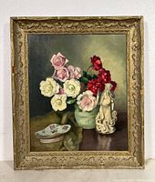 Full view of the framed oil painting showing flowers, porcelain shoe, figurine, and the decorative frame.