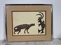 Full view of framed Inuit print with metal frame and double matting showing overall condition and style.