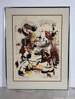 Full view of framed abstract watercolour painting with signature and numbering visible on the painting edges.