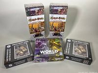 Photo showing two Clash of Rage The Worshippers of Nivi board games, one It's a Wonderful World Corruption & Ascension Expansion board game, and two Vintage Hockey Gloves 1000-piece jigsaw puzzles.