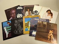 Photo showing a spread of 10 assorted vinyl record albums including Carly Simon, Paul Simon, Leon Redbone, Rare Earth, Barbra Streisand, Boz Scaggs, Gino Vannelli, and Eddie Gittens.