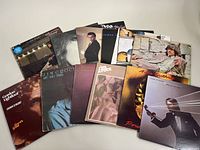 Top-down view of all 10 record albums showing covers and variety of artists and genres.