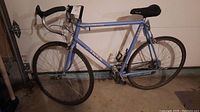Side view of blue Trek 1420 road bicycle showing frame, wheels, and saddle.