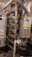 Full view of 8-ft metal step ladder showing overall condition in a utility room environment with furnace and water heater nearby.