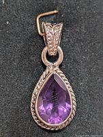 Close-up front view of the silver amethyst pendant showing the pear-shaped faceted amethyst and intricate silver setting