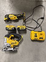 Overview of all items: multi-tool, jigsaw, two batteries and charger