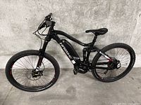 Full side view of bike showing frame, wheels, suspension and motor