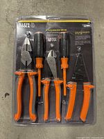 Photo shows sealed Klein Tools 278 5-piece insulated tool kit with pliers, screwdrivers and wire stripper in original packaging.