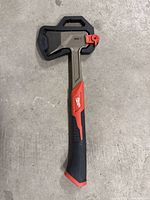 Front side view of Milwaukee 26oz axe with protective sheath on blade, showing handle grip and brand logo.
