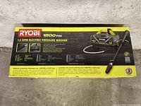 Boxed Ryobi 1800 PSI electric pressure washer showing model, specs and image of unit
