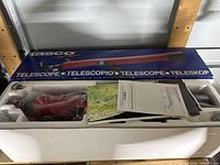 Fully packed Tasco telescope in white styrofoam inside original box, showing telescope tube and manuals.