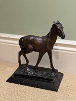Three-quarter view of bronze horse sculpture on rectangular base