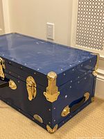 Side angled view showing latch lock, handle, and metal corner.