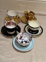 All five tea cup and saucer sets displayed together