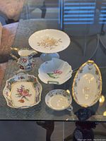 All six bone china pieces displayed on a glass table