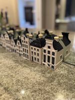 Row of 14 ceramic houses reflected in mirror