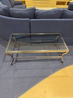 Coffee table front view on carpet with couch background