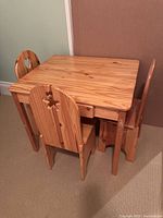 Full view of pine kids table with three matching chairs