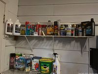 Shelf full of assorted garden care products including fertilizers, sprays, and cleaners arranged with labels visible.