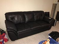 Full view of black three-seat leatherette sofa