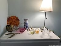 Overview of lot with all items on white surface under light.