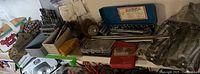 Wide view of all items showing drill bits, wrench sets, socket sets, wire brushes, and other hand tools