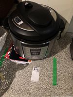 Front view of Instant Pot IP-LUX showing overall unit including base, control panel, and partial lid.