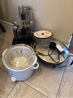 View of all three items together: Hamilton Beach food processor, Rival crock pot, and Oster fry pan on the floor.