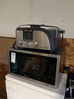 Both items shown together with WestBend breakfast maker stacked on Magic Chef microwave.