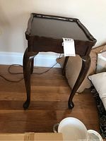 Full view of the Bombay Co. occasional table showing the Queen Anne style legs and scalloped edge top.