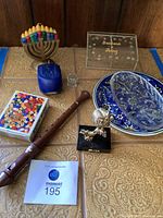 Overview of lot: owl sculpture, puzzle box, menorah, candles, shot glass, lucite box, crystal dish, plate, recorder