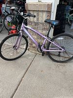 Side view of the entire purple Diamondback girls bike with black seat and handlebars.
