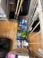 Multiple boxed and packaged items including Dalek popcorn bowl and other collectibles stacked on floor.