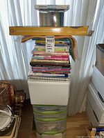 Photo of stacked craft books and sketch pads on top of plastic storage drawers