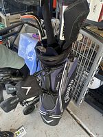 Overview of Callaway Xtreme stand bag loaded with left-handed clubs and head covers on a pull cart
