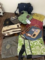 Photo showing various side bags, including denim leather patchwork bag, green Haiku bag and blue crossbody bag.