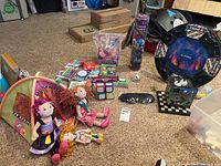 Overview of lot contents including dolls, tent, games, and Lego stadium