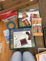 Overview photo of lot showing all items including boxes and yarn kits
