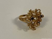 Side view showing floral cluster and sapphire accents