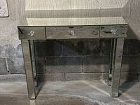 Front-facing view of entire console table against block wall.