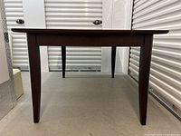 Front view of table showing tapered legs and apron