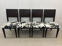 Front view of four chairs aligned side by side showing full set