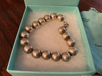 Bracelet arranged inside Tiffany blue box on foam pad