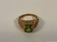 Top view showing emerald cut peridot and filigree setting
