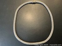 Full view of flexible woven sterling silver chain laid flat