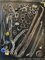 Overhead view of entire lot showing necklaces, rings, earrings, pendants, bracelet