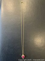 Full view of necklace laid flat on black surface