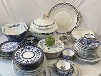 Overview of assorted blue and white dinnerware on white backdrop