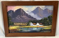 Full frontal view of framed painting against draped backdrop